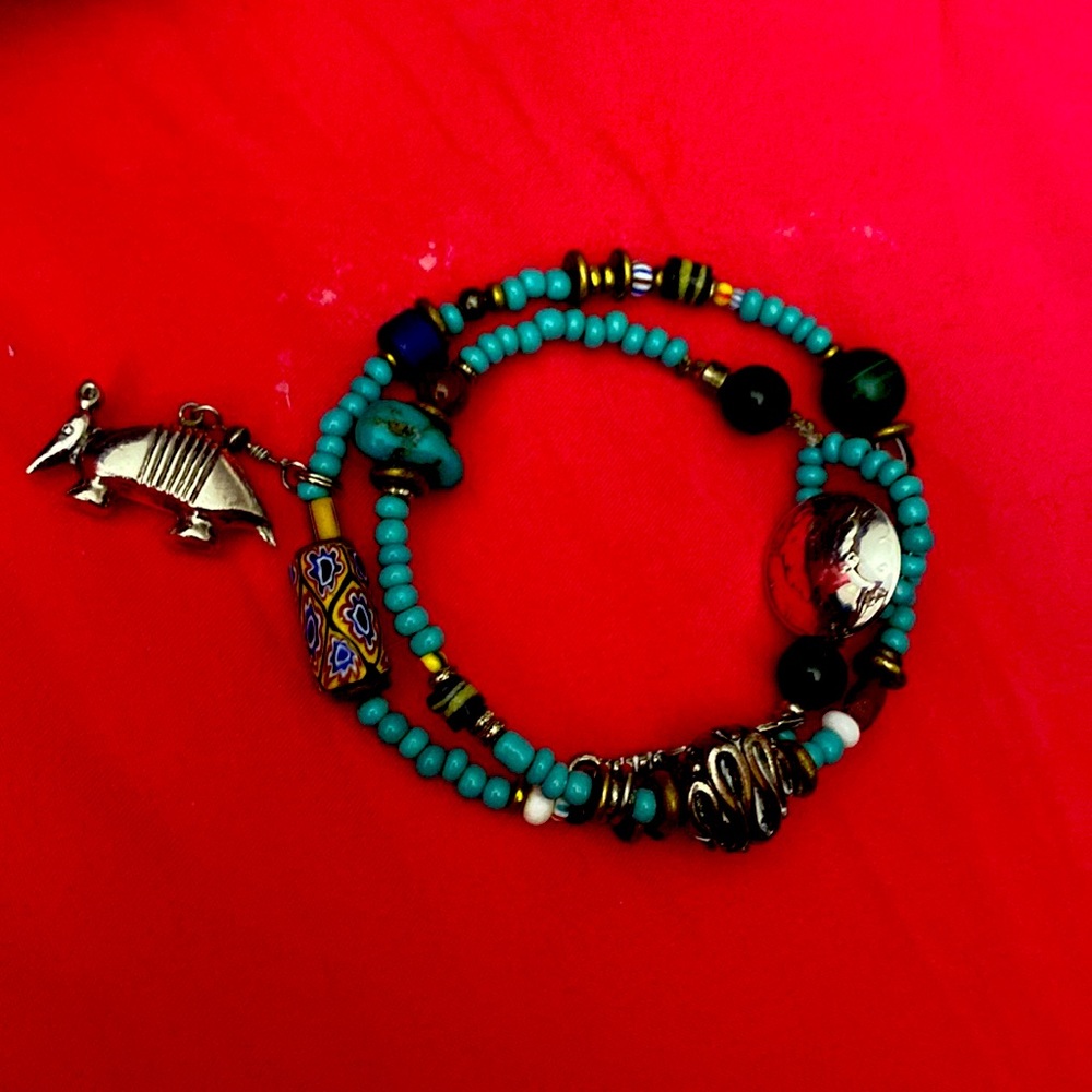 Turquoise multicolor beaded bracelet Aardvark , coin , feather charms